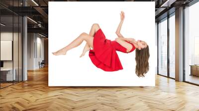 young woman in red dress falling with closed eyes isolated on white Wall mural