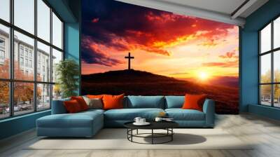 A stunning sunset casts vibrant colors over a hilltop cross, symbolizing peace and reflection in nature. Wall mural