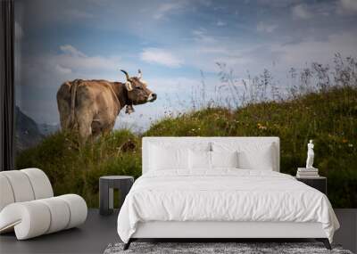 Brown mountain cows grazing on an alpine pasture in the Bernese Alps in summer. Grindelwald, Jungfrau region, Bernese Oberland, Switzerland Wall mural