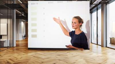 Pretty, young business woman giving a presentation Wall mural