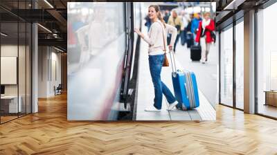 pretty young woman boarding a train (color toned image) Wall mural