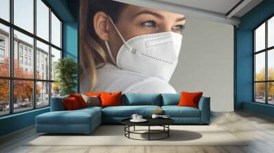 Young woman wearing a face mask during coronavirus and flu outbreak. Virus and illness protection, home quarantine. COVID-19 concept Wall mural