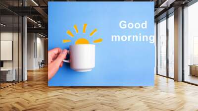 sun and white cup on blue background Wall mural