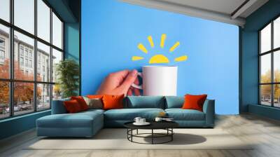 sun and white cup on blue background Wall mural