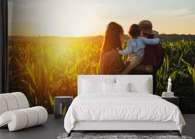 Happy family in corn field. Family standing in corn field an looking at sun rise Wall mural