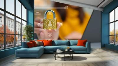 Cybersecurity concept. A person is holding onto a padlock containing a data privacy protection system from digital threats. Protect hardware, software and applications connect to work on the Internet. Wall mural