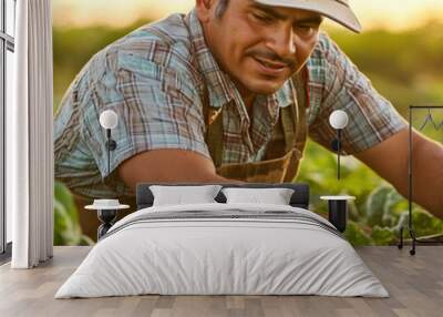 Hispanic male farmer harvesting vegetables in a field, using machinery. Wall mural