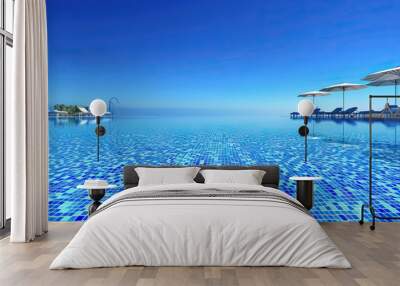 Sapphire Blue Swimming Pool: A crystal-clear swimming pool with loungers and umbrellas scattered around, accentuated by a bright blue color Wall mural