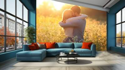 Two friends, one male and one female, sharing a friendly hug in a sunny meadow. Wall mural