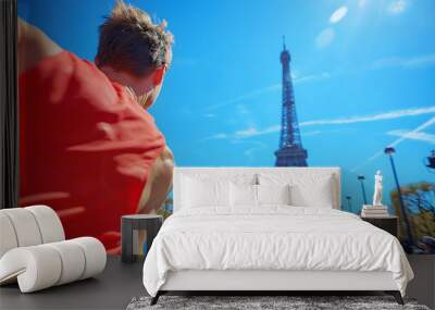 Male runner completing marathon with Eiffel Tower in background. Runner in Paris, France. Sporting event or olympics concept. Editorial, advertising. Spacy text. Wall mural