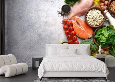 Assortment of healthy protein sources and body building food : meat, fish, fruits, vegetables, legumes, nuts, cereals and dairy products.Top view with copy space. Wall mural