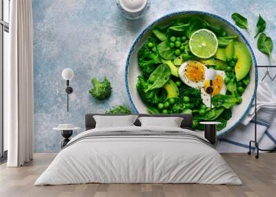 Green vegetable salad with avocado, broccoli, pea and boiled eggs.Top view with copy space. Wall mural