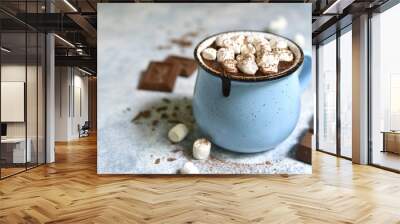 Homemade hot chocolate with mini marshmallow in a blue enamel mug.Rustic style. Wall mural