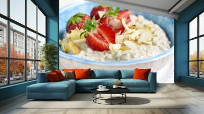 Oat porridge with fresh strawberry for a breakfast. Wall mural