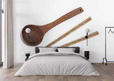 a wooden spoon and a pair of chopsticks on a white background Wall mural