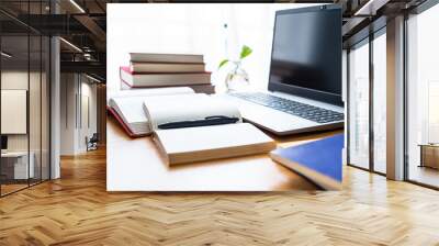 Laptop and book study materials on the desk Wall mural