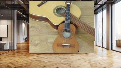 Close-up of an acoustic guitar and a Brazilian string musical instrument: cavaquinho, on a wooden surface. They are widely used to accompany samba and choro, two popular Brazilian rhythms. Top view. Wall mural