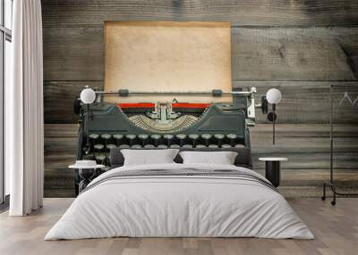 Antique typewriter with grungy worn paper page on wooden table Wall mural