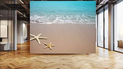 Two starfish on a beach. Sand and sea wave. Wall mural