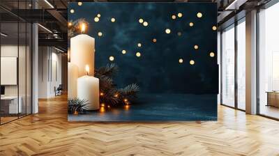 A beautiful arrangement of white candles rests atop lush evergreen branches, surrounded by soft golden ornaments, all illuminated by twinkling holiday lights in the background Wall mural