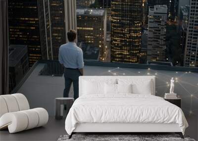 A businessman stands on a rooftop, observing illuminated photos linked by lines against a night city backdrop, embodying modern connectivity Wall mural