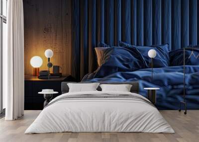 a modern bedroom at night with an unmade bed, focusing on a closeup view of a grey headboard and blue sheets illuminated by warm bedside lamp lighting. Wall mural