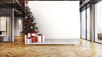 A solitary white Christmas tree adorned with snow stands elegantly against a pure white backdrop, complemented by neatly wrapped red and white gifts on the floor Wall mural