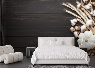 A stunning arrangement of cotton, wheat, and pumpkins captures the essence of autumn on a dark wooden backdrop, creating a warm and inviting atmosphere Wall mural