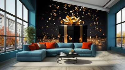 a stylish gift box with a beautifully tied ribbon bow, nestled amidst golden confetti on a sleek black background. The composition exudes sophistication and celebration. Wall mural