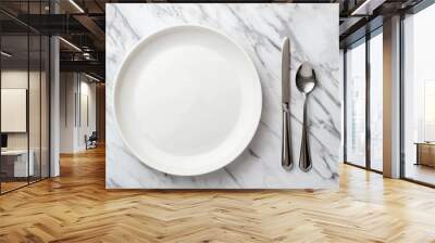 A white dinner plate sits on a marble tabletop with a cloth napkin beside it, along with two black forks and a knife. Wall mural