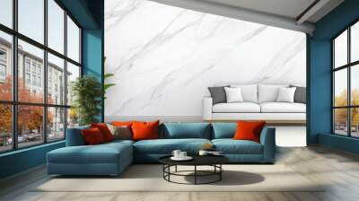 The cozy living space highlights a white marble wall behind a sleek sofa adorned with cushions, complemented by decorative plants for a tranquil atmosphere Wall mural