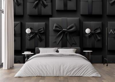 The image showcases an arrangement of stylish black gift boxes adorned with ribbons and bows, set against a dark background. Ideal for Black Friday advertising and holiday retail themes Wall mural