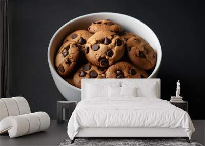 Chocolate chip cookies in a white bowl on a black background. Wall mural