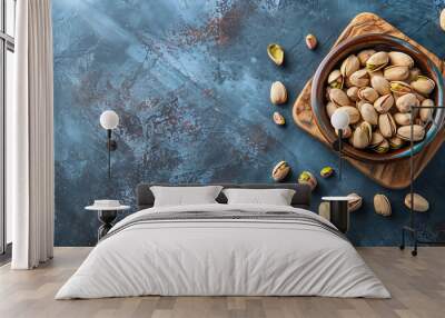 Top-view pistachios Fresh nuts in bowl on kitchen board Wall mural