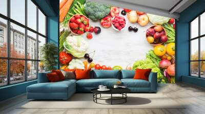 Fresh farm produce frame, fruits vegetables berries, apples cherries peaches strawberries cabbage broccoli cauliflower squash tomatoes carrots beans beetroot copy space, top view, selective focus Wall mural