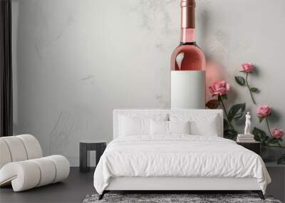 A bottle of wine with a white label sits on a table next to a bunch of pink roses Wall mural