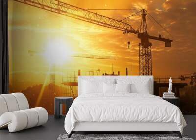 A construction site with a crane and a sun in the background Wall mural