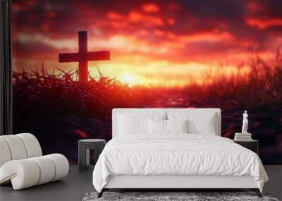 A cross is standing in a field of grass with a sunset in the background Wall mural