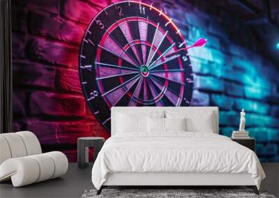 A dartboard, mounted on a brick wall, is bathed in vibrant neon light. A single dart is embedded in the board, suggesting a recent game Wall mural