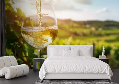 A glass of wine is poured into a wine glass Wall mural