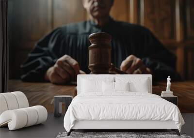 A judge sits at a wooden desk, poised with a gavel, as a lawyer prepares for legal arguments in a focused courtroom setting Wall mural