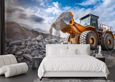 A large yellow wheel loader dumps a pile of rocks on a sunny day in a quarry Wall mural