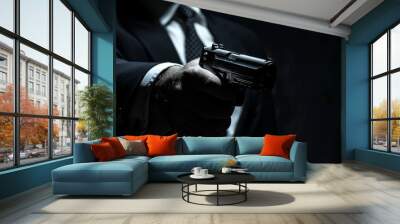 A man is holding a gun in his hand Wall mural