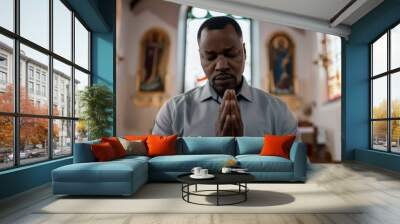 A man is praying in a church Wall mural