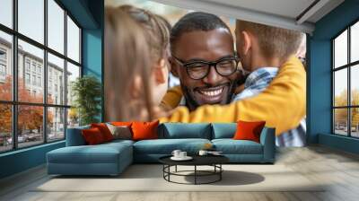 A man with glasses is hugging a group of children Wall mural