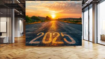 A road with a sun setting in the background and the number 2025 written on it Wall mural