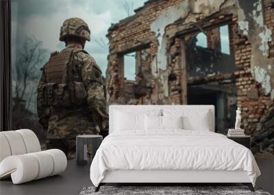 A soldier stands in front of a destroyed building Wall mural