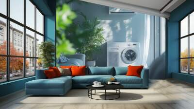 A white washing machine sits in front of a window with a plant in a pot Wall mural