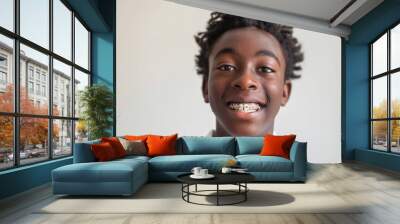 A young man with braces on his teeth is smiling Wall mural