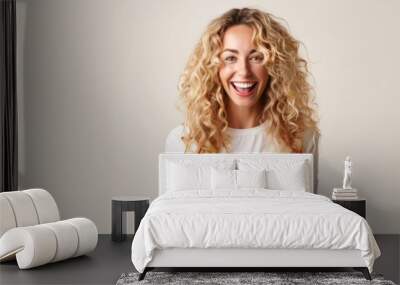 Close up photo of cute blonde woman holding plate with spaghetti, smiling look at camera on grey background. Copy space. Bolognese pasta. Woman cooked spaghetti. Italian food and menu concept. Wall mural